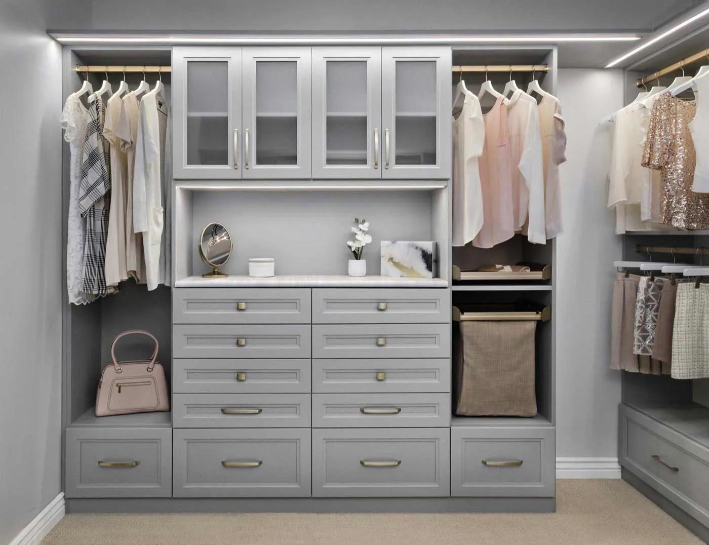 Custom walk-in closet with LED-lit shelving and drawer stacks, designed and installed in Huntington Beach by ClosetsOC